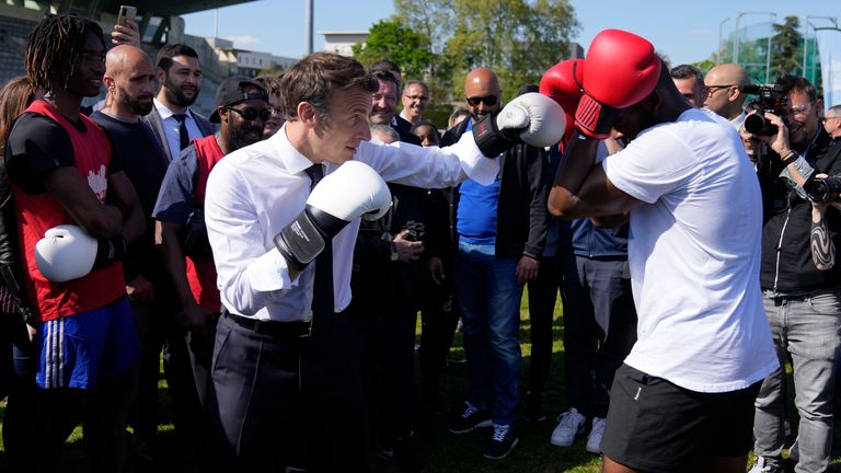 French President Emmanuel Macron training with amateur boxer Jean-Denis Nzaramba in 2022. Pic: AP