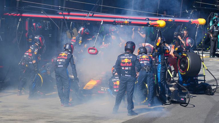 Mechanics work to extinguish a fire in Red Bull driver Max Verstappen of the Netherlands&#39; car during the Australian Formula One Grand Prix at Albert Park, in Melbourne, Australia, Sunday, March 24, 2024. (AP Photo/Scott Barbour,Pool)