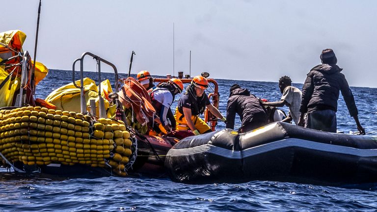 Migrants are helped evacuate a partially deflated rubber dinghy by the rescue personnel of the SOS Mediteranee&#39;s humanitarian ship Ocean Viking in the Central Mediterranean Sea, Wednesday, March 13, 2024. Pic: Johanna de Tessieres/ SOS Mediteranee via AP, HO