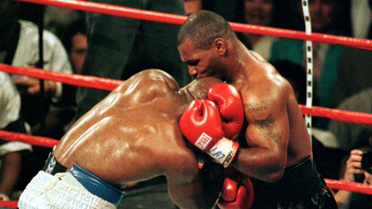 Mike Tyson bites the ear of Evander Holyfield during the third round of their Nevada fight. Pic: Reuters