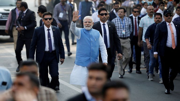 FILE PHOTO: India&#39;s Prime Minister Narendra Modi waves to his supporters as he arrives to cast his vote during the second and last phase of Gujarat state assembly elections in Ahmedabad, India, December 5, 2022. REUTERS/Amit Dave/File Photo