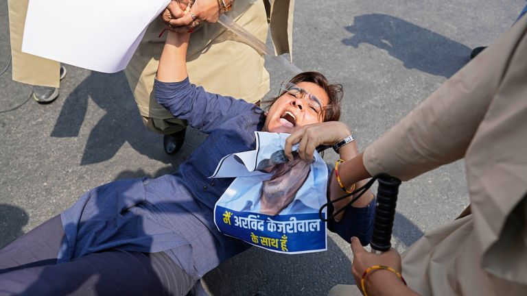 A supporter of Aam Admi Party shouts slogans as she is detained by the police.
Pic: AP