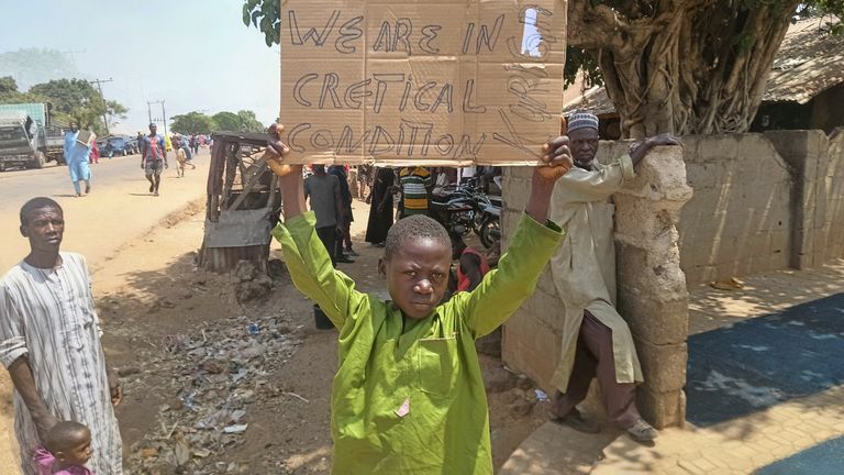 A boy holds a sign to protest against, what a teacher, local councillor and parents said, the kidnapping of hundreds school pupils by gunmen after the Friday prayer, in Kaduna, Nigeria March 8, 2024. Pic: Reuters