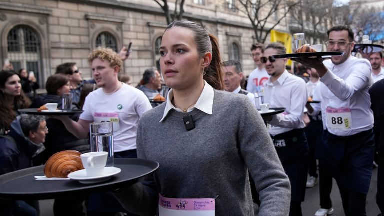 Pic: AP
Waiters carry trays with a cup of coffee, a croissant and a glass of water as they take part in a waiter&#39;s run through the streets of Paris, Sunday, March 24, 2024. (AP Photo/Christophe Ena)