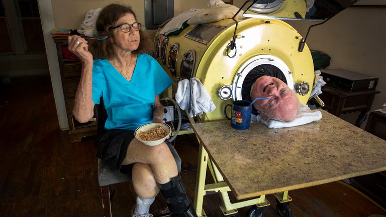 Paul Alexander chats with caregiver and friend Kathy Gaines as he drinks coffee.
Pic: The Dallas Morning News/AP                                                                                                    
