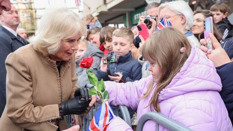 Queen Camilla smiles after receiving a red rose from Abi Crighton during a visit to the Farmers&#39; Market in The Square, Shrewsbury.
Pic: PA

