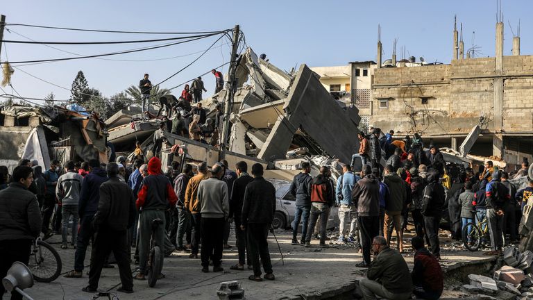 Palestinians in Rafah on Sunday search the rubble of a home following an Israeli air strike. Pic: Abed Rahim Khatib/picture-alliance/dpa/AP