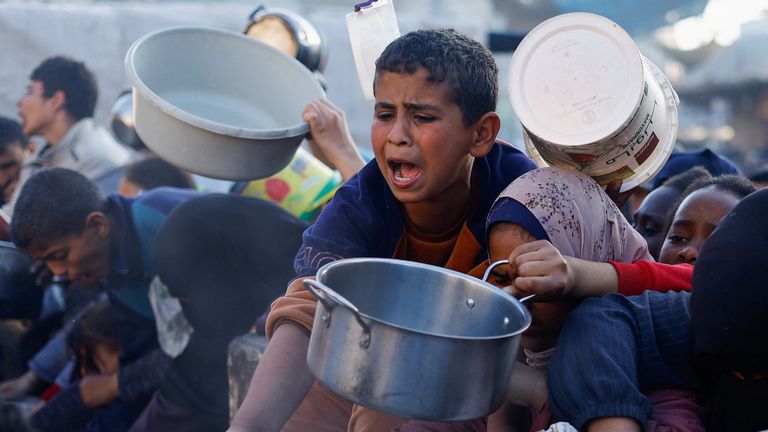 Children wait to receive food in Rafah, in the southern Gaza Strip. Pic: Reuters