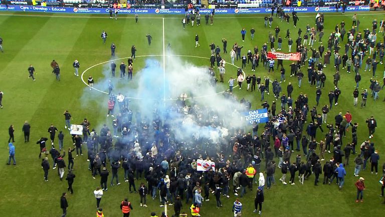 A pitch invasion at Reading FC against with supporters raging against the ownership of their club
