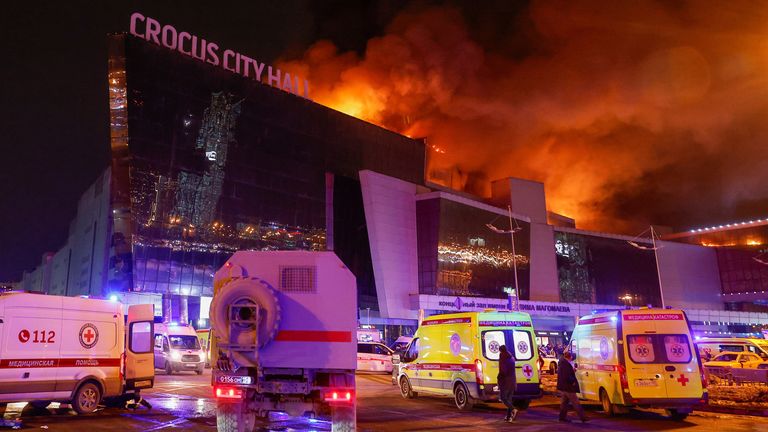 Vehicles of Russian emergency services are parked near the burning Crocus City Hall concert venue following a reported shooting incident, outside Moscow, Russia, March 22, 2024. REUTERS/Maxim Shemetov