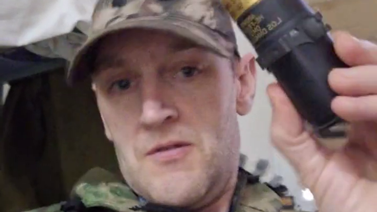 DO NOT PUBLISH UNTIL CLEARED

Ben Stimson waves a captured Ukrainian grenade. Pic: Ben Stimson