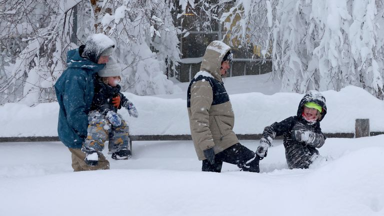 A family struggle through the snow in Truckee, California. Pic: Jane Tyska/Bay Area News Group via AP