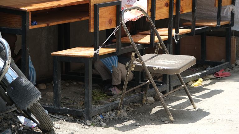 Stuart Ramsay eyewitness Haiti turmoil - child plays under desk