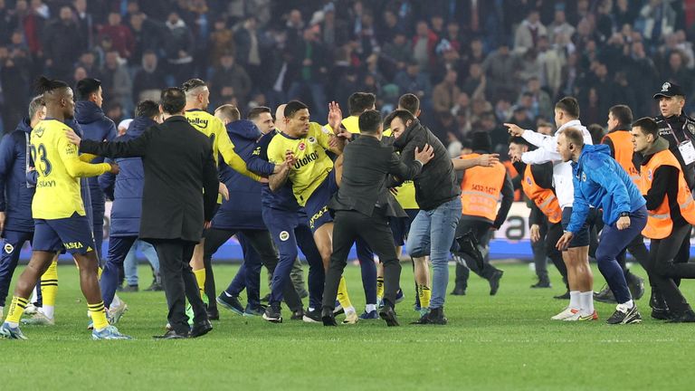 Soccer Football - Super Lig - Trabzonspor v Fenerbahce - Papara Park, Trabzon, Turkey - March 17, 2024 Trabzonspor fans invade the pitch and clash with Fenerbahce players and security staff after the match. REUTERS/Depo Photos TURKEY OUT. NO COMMERCIAL OR EDITORIAL SALES IN TURKEY.