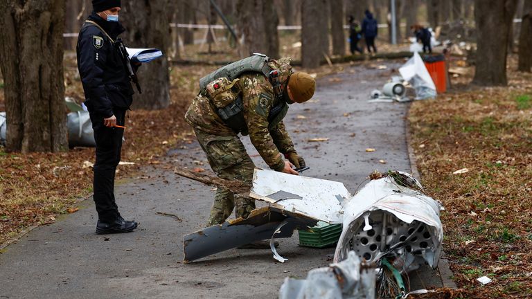 Police officers inspect remnants of Russian missiles in Kyiv on Sunday. Pic: Reuters