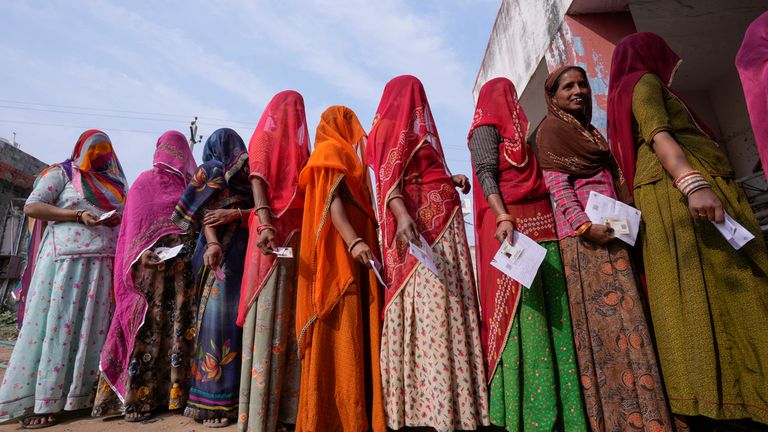 FILE- Women stand in a queue to cast their votes in Chachiyawas village, near Ajmer, India, Nov. 25, 2023. India...s top court on Thursday struck down a controversial election funding system that allowed individuals and companies to send unlimited donations to political parties without any need to disclose donor identity, a system critics have long said is undemocratic and favored Prime Minister Narendra Modi&#39;s ruling party. (AP Photo/ Deepak Sharma, File)