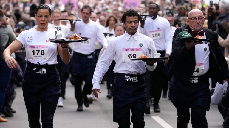 Pic: AP
Waiters carry trays with a cup of coffee, a croissant and a glass of water as they take part in a waiter&#39;s run through the streets of Paris, Sunday, March 24, 2024. (AP Photo/Christophe Ena)