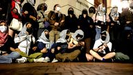 Protesters link arms outside Hamilton Hall barricading students inside the building at Columbia University.
Pic: Reuters