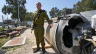 Israeli military spokesperson Daniel Hagari stands next to one of the Iranian ballistic missiles Israel intercepted. Pic: AP