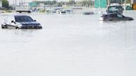 Vehicles sit abandoned in floodwater covering a major road in Dubai.
Pic: AP