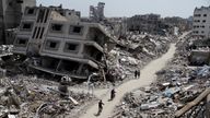 Palestinians ride bicycles past the ruins of houses and buildings destroyed during Israel’ military offensive, amid the ongoing conflict between Israel and the Palestinian Islamist group Hamas, in the northern Gaza Strip March 31, 2024. REUTERS/Mahmoud Issa