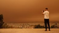 A man takes pictures as African dust from the desert of Sahara covers the city of Athens, Greece.
Pic: Reuters