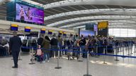 Passengers queue in Heathrow Airport. Pic: PA