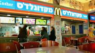FILE PHOTO: Israeli customers at a McDonald&#39;s restaurant in Tel Aviv March 2, 2006. REUTERS/Ronen Zvulun/File Photo