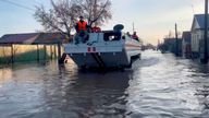 Rescuers in an amphibious vehicle search for stranded people in Orsk