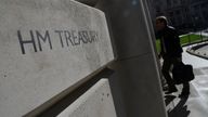 A worker walks into the Treasury building in London, Britain, October 11, 2022. REUTERS/Toby Melville