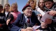 File photo dated 05/06/23 of D-Day veteran Bill Gladden, 6th Airborne Army Recce Regiment RAC meeting local French schoolchildren at the British Normandy Memorial at Ver-sur-Mer in France ahead of the 79th anniversary of the D-Day landings. 100-year-old WWII veteran William &#39;Bill&#39; Gladden, who flew into Normandy on D-Day, died this morning at his home in Haverhill, Suffolk, the Taxi Charity for Military Veterans has announced. Issue date: Wednesday April 24, 2024.

