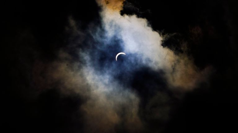 Clouds cover the sky prior to a total solar eclipse, Monday, April 8, 2024, in Arlington, Texas. (AP Photo/Julio Cortez)