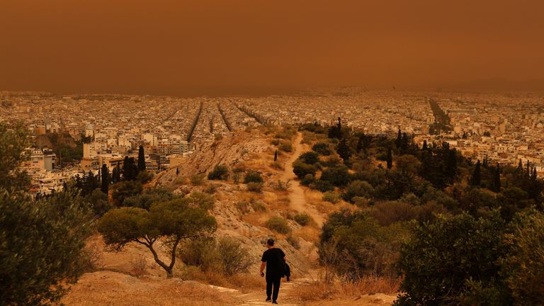 A man makes his way at a hill as African dust from the desert of Sahara covers the city of Athens, Greece.
Pic Reuters
