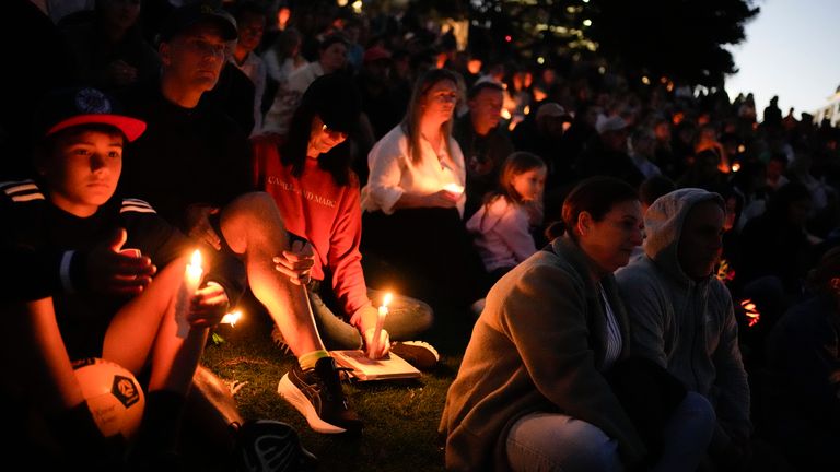 Mourners hold candles at a vigil for victims of the Bondi shopping mall stabbing. Pic: AP