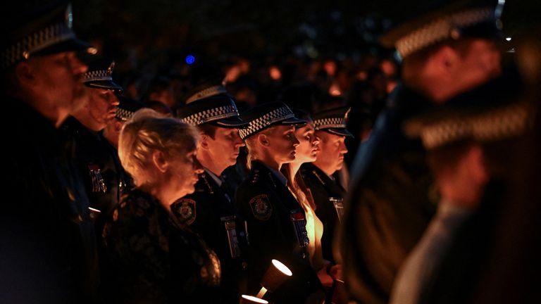 Amy Scott at the Community Candlelight Vigil with other police officers. Pic: Reuters