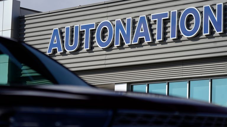 The automotive group sign for Autonation hangs over the hood of an unsold 2020 Explorer sports-utility vehicle at a Ford dealership Sunday, Oct. 11, 2020, in Littleton, Colo. (AP Photo/David Zalubowski)...
