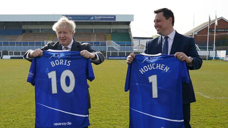 Jill Mortimer, Conservative party candidate for Hartlepool, Britain&#39;s Prime Minister Boris Johnson, and Ben Houchen, Tees Valley Mayor, from left, are presented with personalized Hartlepool United shirts in 2021. File pic: AP