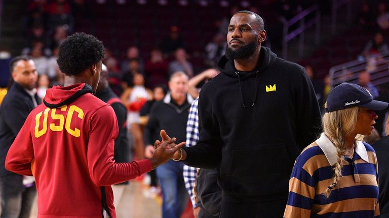 LOS ANGELES, CA - JANUARY 06: USC Trojans guard Bronny James (6) gives his dad LeBron James a high five before the college basketball game between the Stanford Cardinal and the USC Trojans on January 6, 2023 at Galen Center in Los Angeles, CA. (Photo by Brian Rothmuller/Icon Sportswire) (Icon Sportswire via AP Images)
