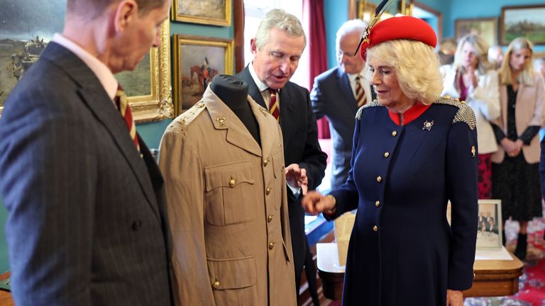 Queen Camilla views the tunic belonging to her late father Major Bruce Shand. Pic: PA