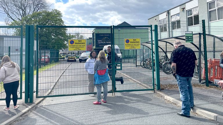 People talk through the gates at the scene of Amman Valley school, in Ammanford, Carmarthenshire.
Pic PA