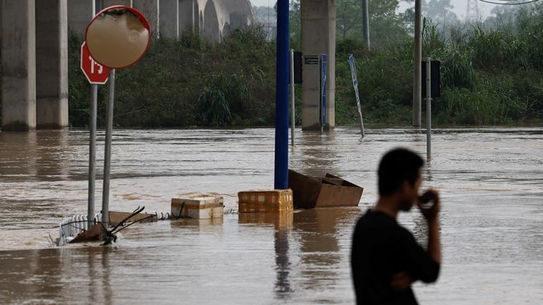 Pic: Reuters
A resident stands near a flooded street following heavy rainfall at the Xiashahe village, in Qingyuan, Guangdong province, China April 22, 2024. REUTERS/Tingshu Wang