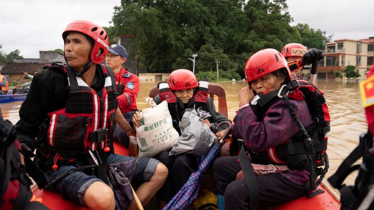 Rescue workers evacuate villagers stranded by floodwaters with a dinghy following heavy rainfall, at Datang village in Yingde, Guangdong. Pic: Reuters