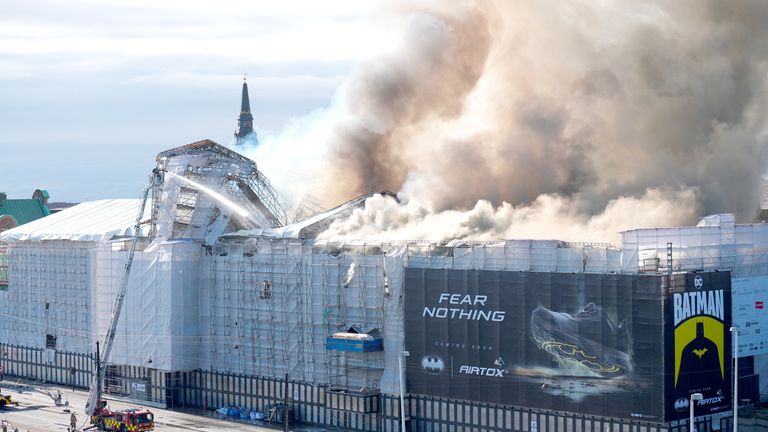 Smoke billows following a fire at the Old Stock Exchange, Boersen, in Copenhagen, Denmark.
Pic: Scanpix/Reuters