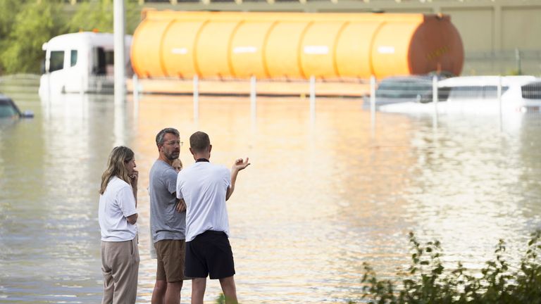 People look out at floodwater covering a major road in Dubai.
Pic: AP