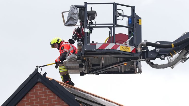 Emergency service workers inspect the roof a property in Knutton.
Pic: PA