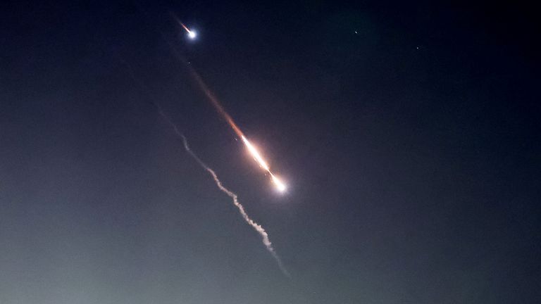 Objects are seen in the sky above Jerusalem after Iran launched drones and missiles towards Israel in Jerusalem
