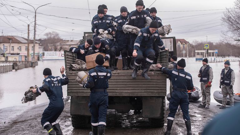 Emergency workers getting off a truck during evacuations in Orsk, Russia, this week. Pic: AP