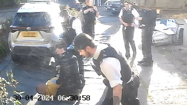 Pic: PA
RETRANSMITTED AMENDING BYLINE..NUMBERPLATE PIXELATED BY PA PICTURE DESK..Handout footage from a doorbell camera of police officers after tasering and detaining a sword-wielding man in Hainault, north east London, after a 14-year-old boy died after being stabbed following an attack on members of the public and two police officers. Picture date: Tuesday April 30, 2024. PA Photo. See PA story POLICE Hainault. Photo credit should read: PA Wire