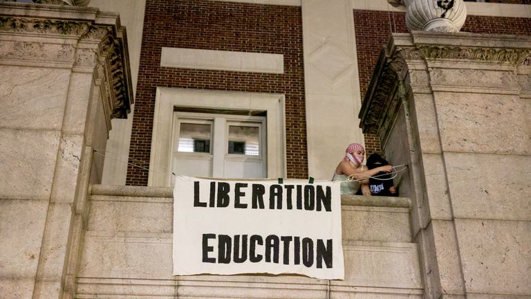 Protesters hang banners on the exterior of Hamilton Hall building.
Pic: Reuters