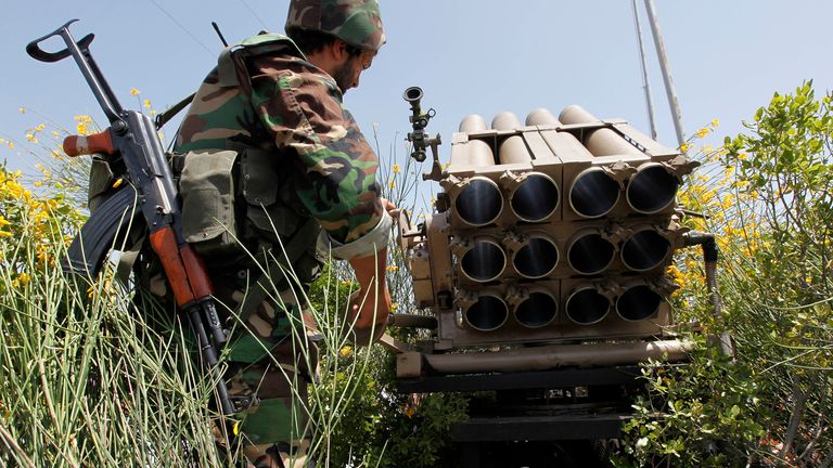 A Hezbollah fighter stands behind an empty rocket launcher in 2010. Pic: AP